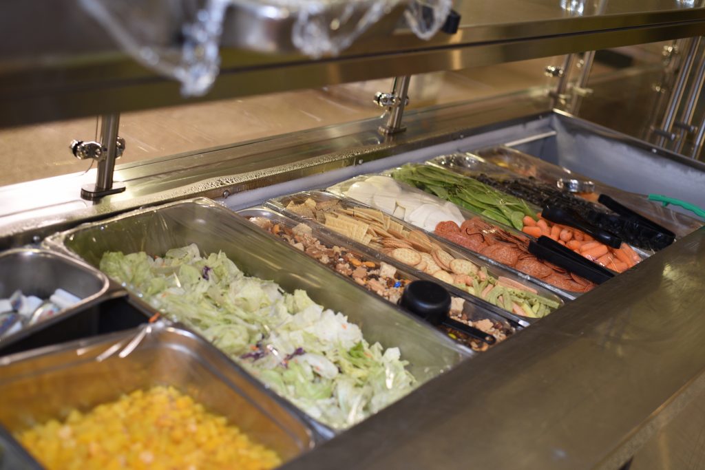 Bins of lettuce, vegetables, nuts, crackers - the salad section in the Dining Hall at PSP