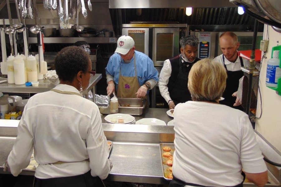 Staff preparing food in the kitchen for the Volunteer Dinner