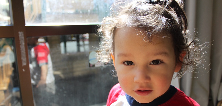 toddler - close-up of girl's face with sun shining in hair