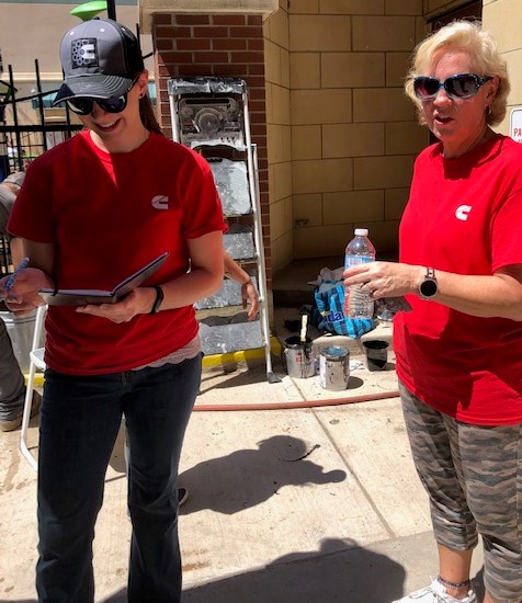 2 women from Cummins who helped with installation of playground equipment