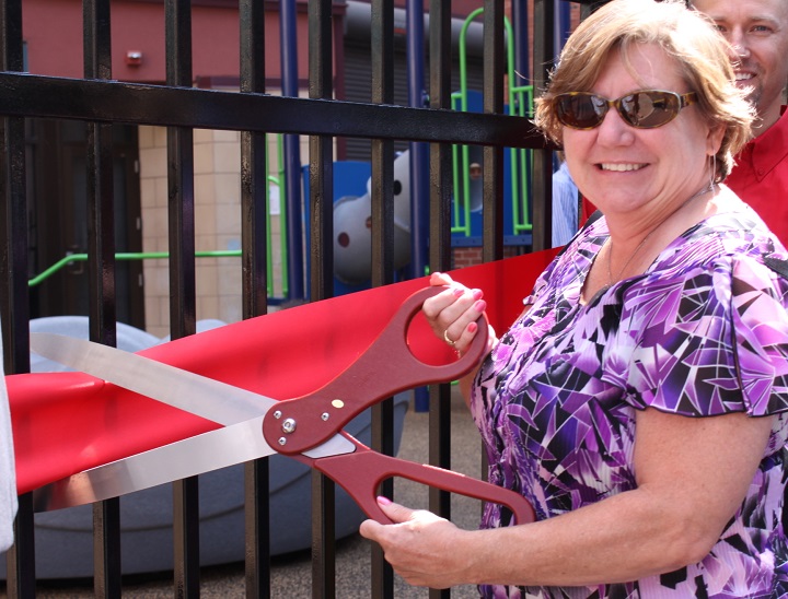 Cutting the ribbon with big scissors