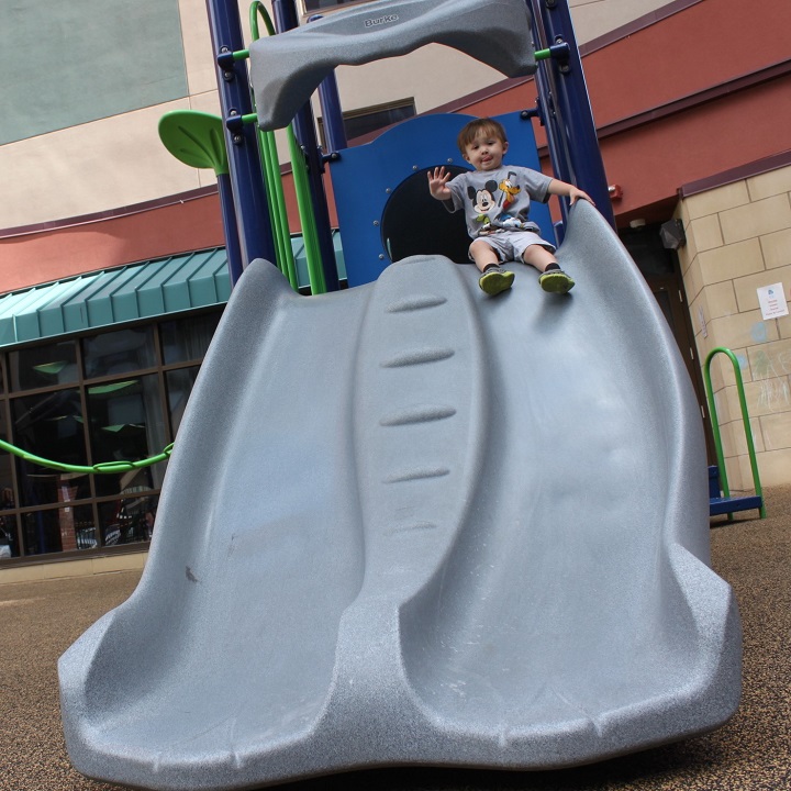 Boy sliding down the new slide