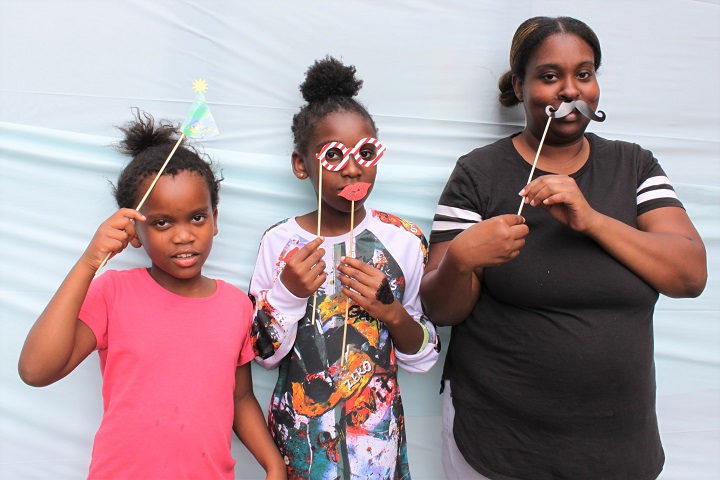 2 girls & their mom pose in photo booth