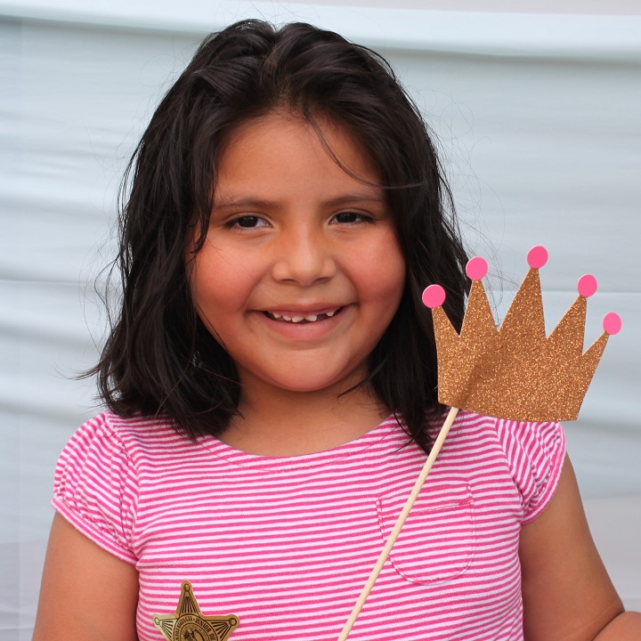 Girl posing with crown in photo booth