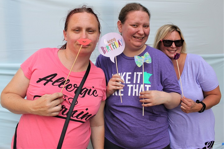 Posing in the photo booth is fun! 3 women posing in photo booth