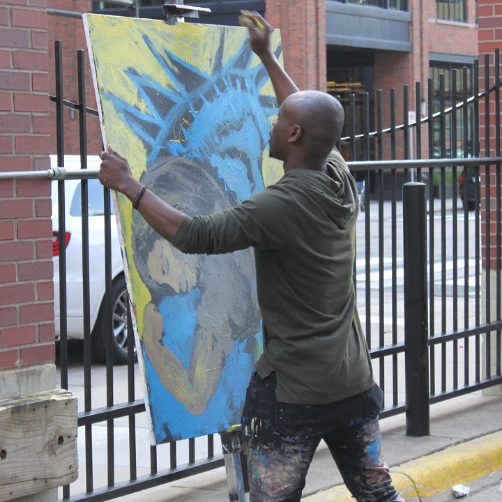 Artist from Free Arts adjusting canvas Artist from Free Arts adjusting canvas