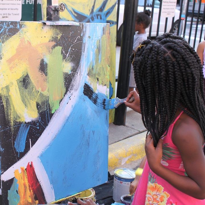 Girl painting on canvas