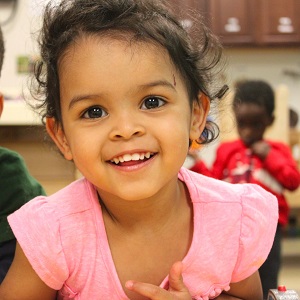 close-up of toddler girl in pink shirt