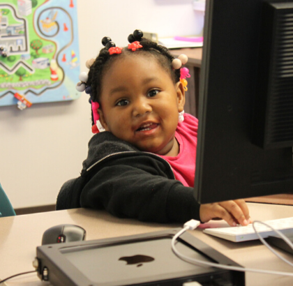 child sitting at computer