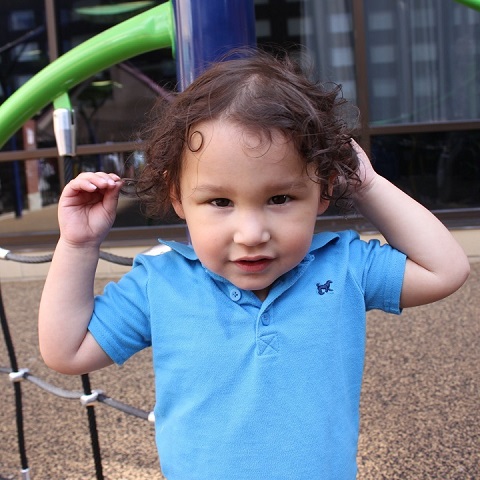 Close-up. Toddler boy in blue shirt.