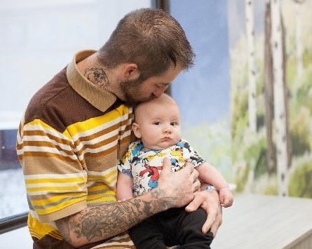 father holding infant