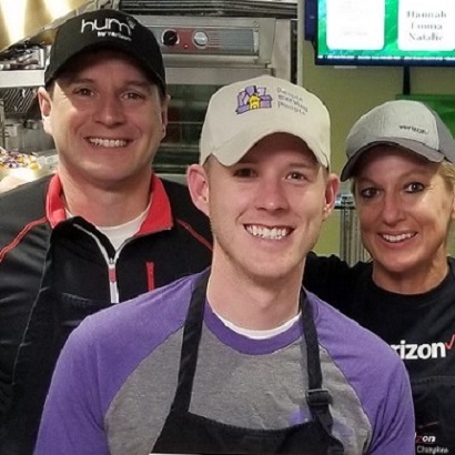 5 volunteers in kitchen aprons