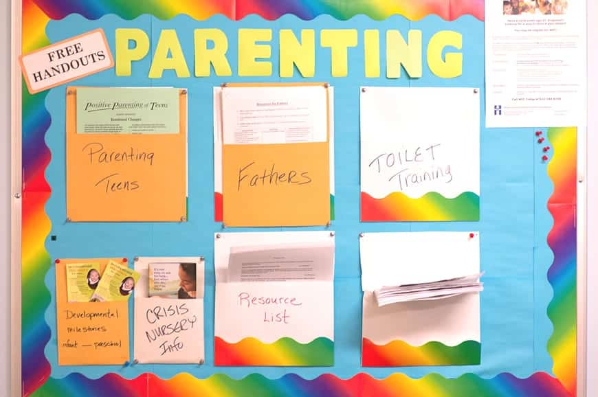 A bulletin board labeled “Parenting” with folders for handouts on parenting teens, fathers, toilet training, and resources.