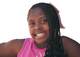 Smiling girl with braided hair and a pink bow, wearing a pink top, against a plain light background.