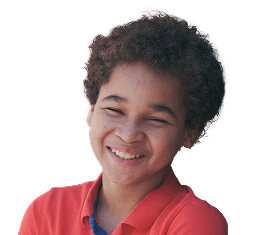 Smiling child with curly hair wearing a red collared shirt, facing the camera against a plain background.