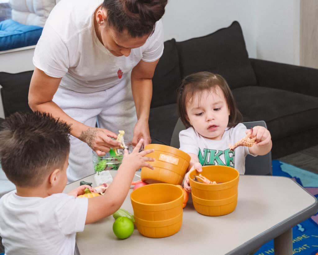 Mother playing with her two young children