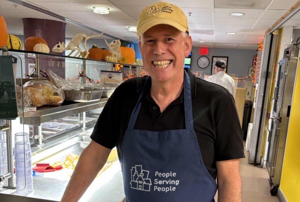 volunteer in kitchen wearing apron